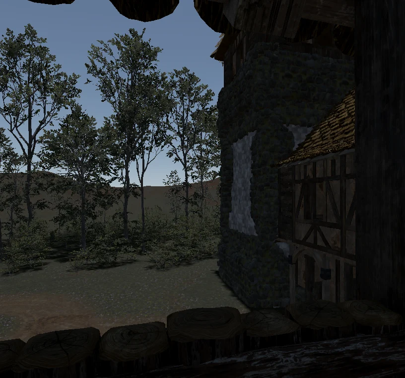 The edge of the tower and the house seen past a row of logs, with tall trees behind