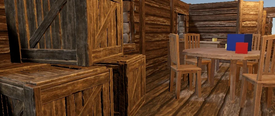 The test room: stacked wooden crates and a round table with chairs, a blue and a red test cube on it